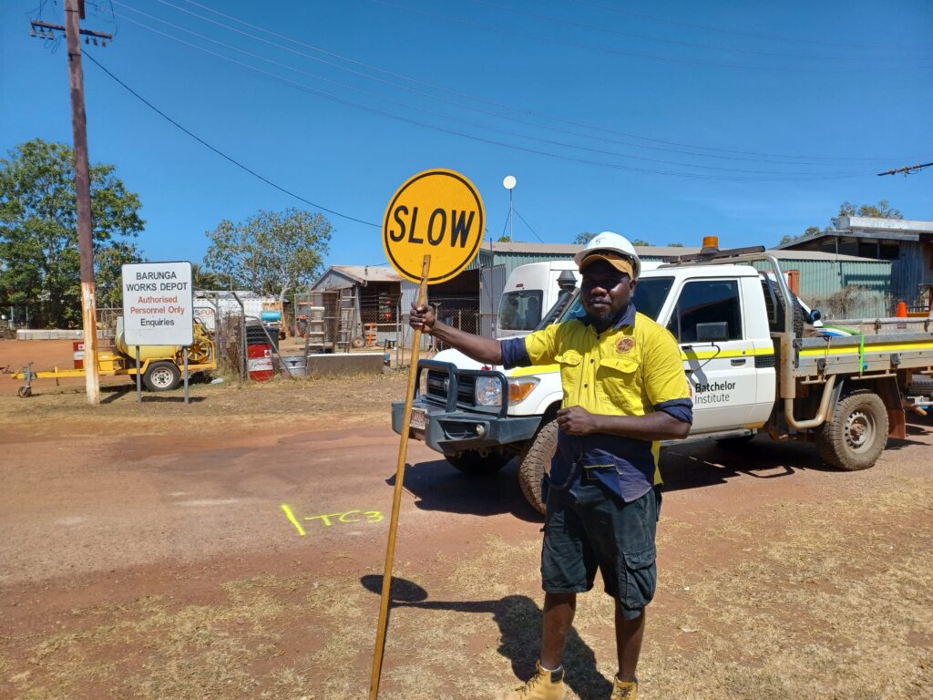 Fulla holding a 'slow' traffic sign